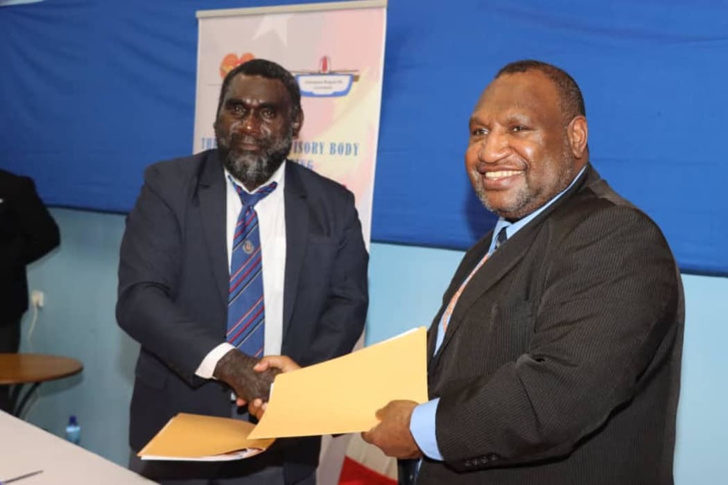 PNG's prime minister James Marape (right) shakes hands with Ishmael Toroama, the president of the autonomous region of Bougainville, 5 February 2021.