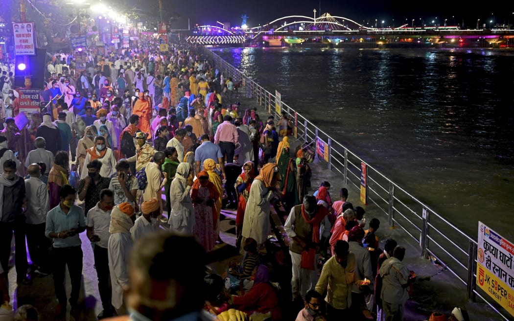 Hindu devotees gather on the banks of Ganges River during the ongoing religious Kumbh Mela festival in Haridwar, north India on April 11, 2021.