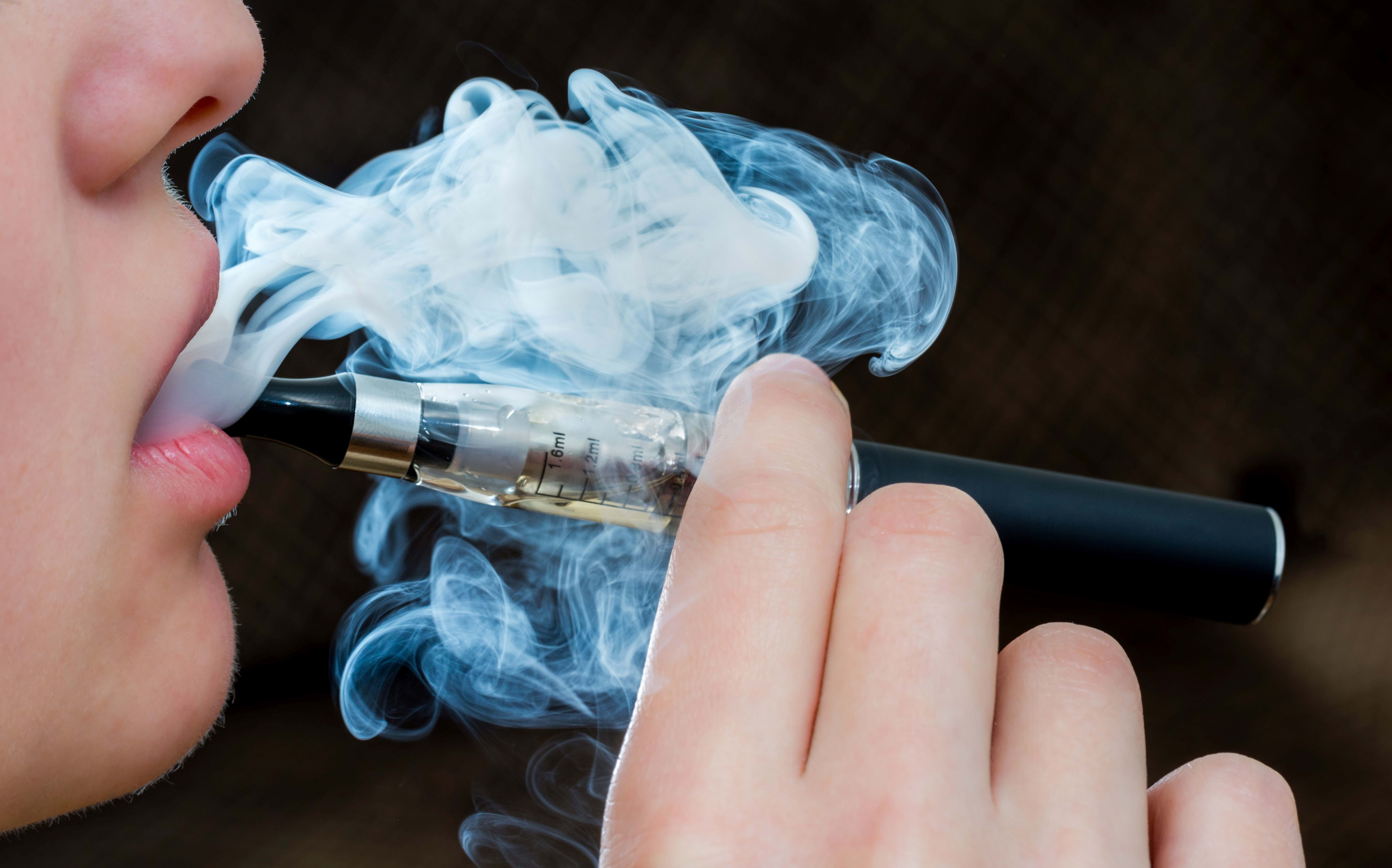 Closeup detail of Female with an Electronic Cigarette, Horizontal shot