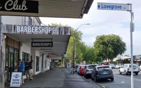 Men queue outside a Hamilton barbershop after Waikato drops to Alert Level 2