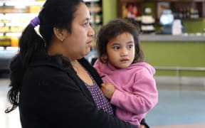 Ioane Teitiota's wife, Angua Erika, with one of the couple's three children at Auckland International Airport on Wednesday 23 September 2015. The family's application to be considered refugees from the effects of climate change in Kiribati has been declined, and Mr Teitiota is being deported today.