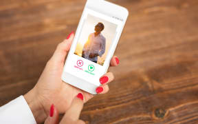 woman looks at online dating profile