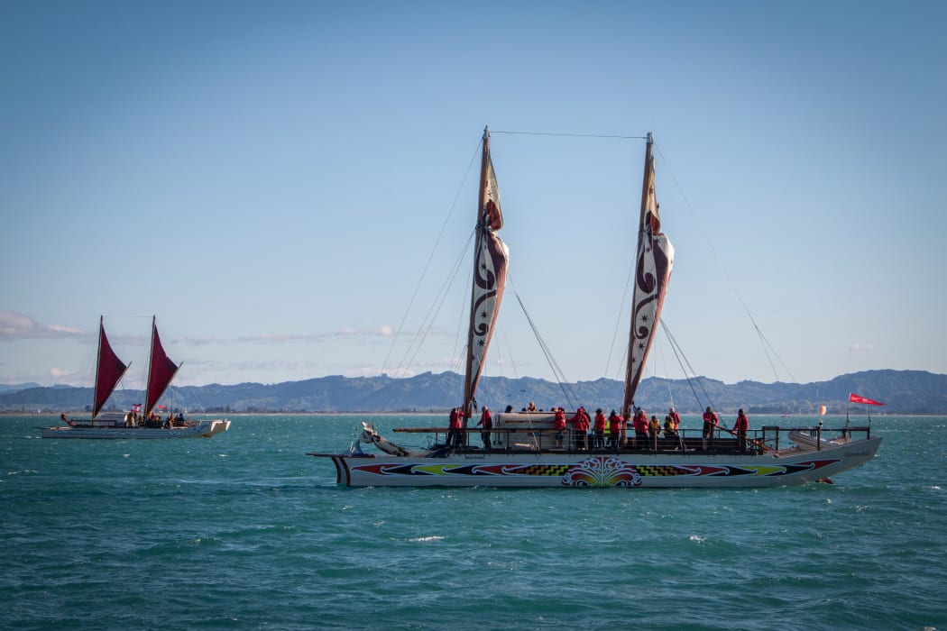 The waka flotilla arrives in the bay as part of the Tuia 250.