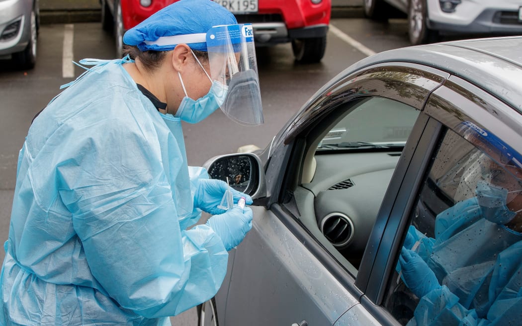 A health worker conducts a test at a COVID-19 coronavirus testing centre in the suburb of Northcote in Auckland on August 12, 2020.