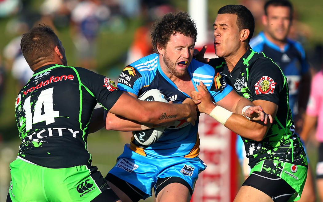 Titans' Jordan Rankin is tackled by Warriors' Carlos Tuimavave and Lewis Brown. NRL Pre Season, Vodafone Warriors v Gold Coast Titans at North Harbour Stadium, Auckland, New Zealand.