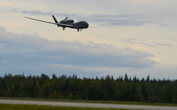A RQ-4 Global Hawk unmanned surveillance drone lands on August 16, 2018, at Eielson Air Force Base, Alaska.