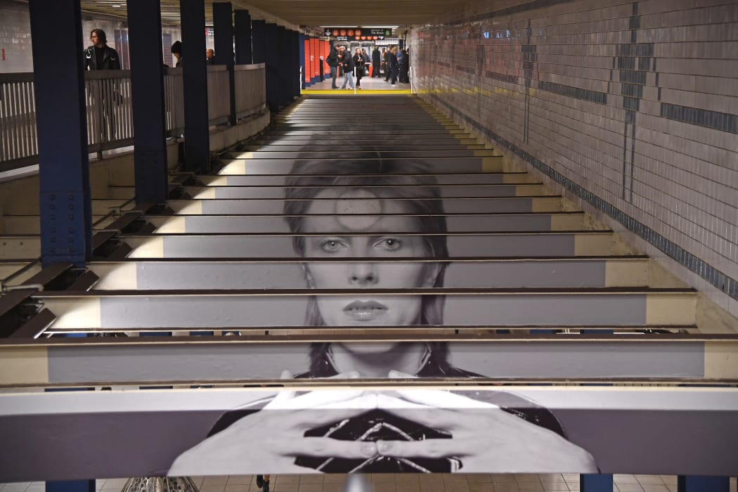 A David Bowie art installation is seen at the Broadway-Lafayette subway station on April 19, 2018 in New York City. The subway-wall-sized images of Bowie-inspired art, is in collaboration with Spotify and the Brooklyn Museum's current exhibition "David Bowie Is." (Photo by ANGELA WEISS / AFP) / RESTRICTED TO EDITORIAL USE - MANDATORY MENTION OF THE ARTIST UPON PUBLICATION - TO ILLUSTRATE THE EVENT AS SPECIFIED IN THE CAPTION