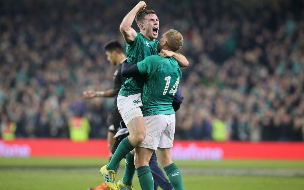Ireland's Luke McGrath (L) celebrates with Ireland's wing Keith Earls on the final whistle in the rugby union test match between Ireland and New Zealand at the Aviva stadium in Dublin on November 18, 2018.