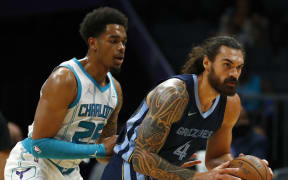 Steven Adams #4 of the Memphis Grizzlies posts up against P.J. Washington #25 of the Charlotte Hornets during the first period of their game at Spectrum Center on October 07, 2021 in Charlotte, North Carolina.