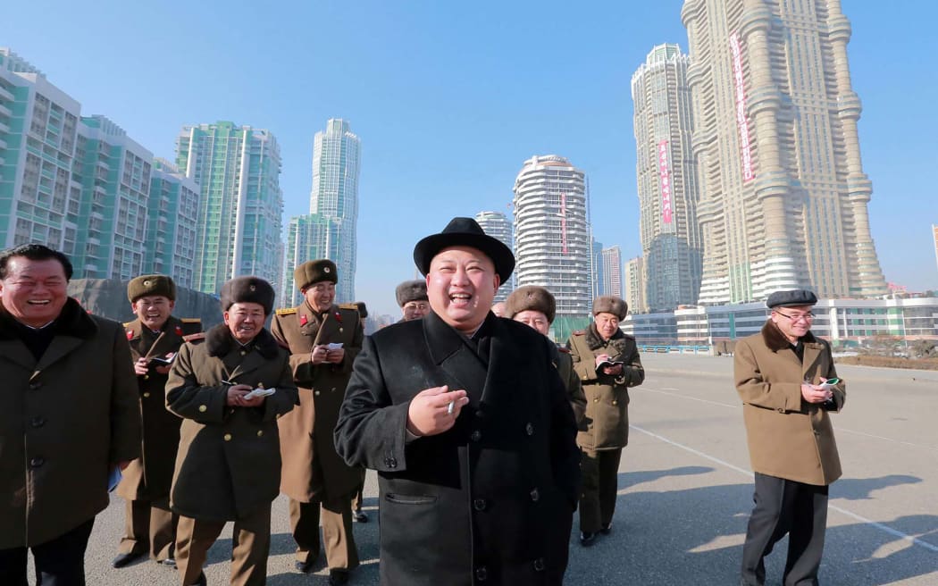 This undated picture released from North Korea's official Korean Central News Agency (KCNA) on 26 January, 2017 shows North Korean leader Kim Jong-Un, centre,  inspecting housing blocks at a construction site at Ryomyong Street in Pyongyang.