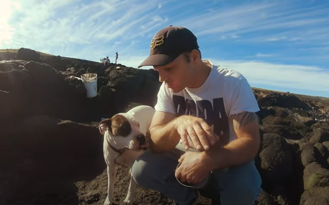Mark Shields on Easter Island coast with his family and dogs.
