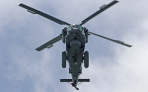 A Sea Sprite helicopter from No. 6 Squadron flies over the Treaty Grounds on Waitangi Day 2021.