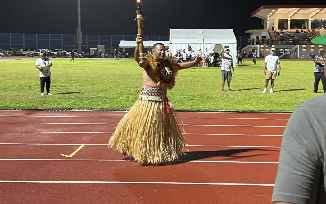 Thousands crowded into the track field for the Micronesian Games opening ceremony, focusing their phone cameras on the lighting of the Games flame by Marshall Islands wrestling star Waylon Muller