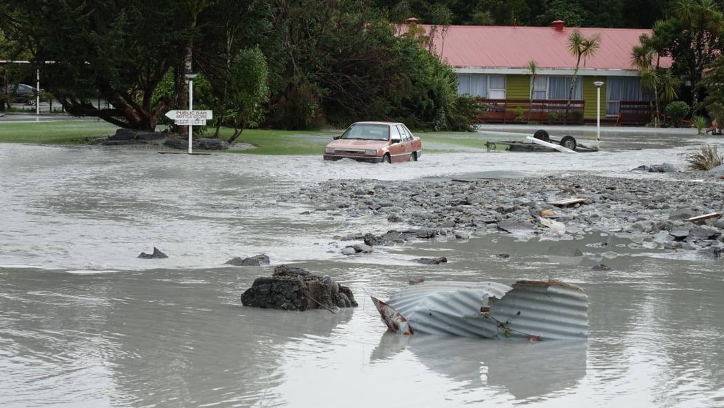 The Waiho River bursts its banks and runs through the Mueller Hotel in Franz Joseph