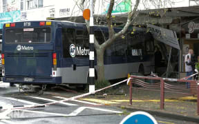 Bus hits pedestrians and crashes into store front