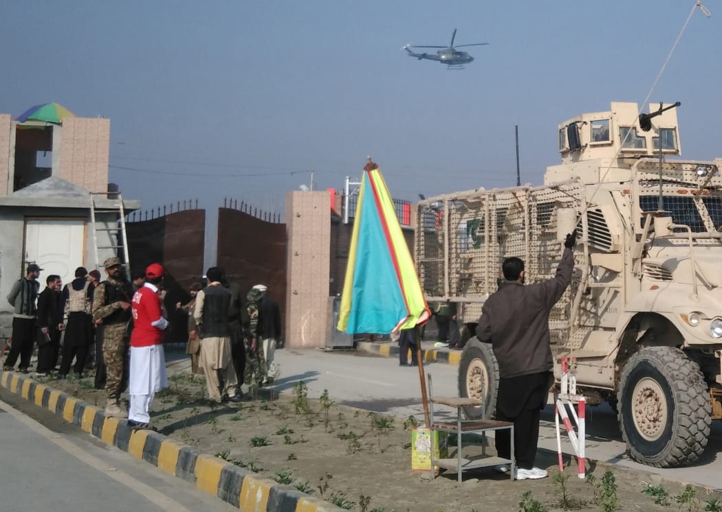 A Pakistani army armoured vehicle (R) enters the Bacha Khan university following an attack by gunmen in Charsadda, about 50 kilometres from Peshawar, on January 20, 2016