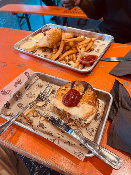 A pulled pork pie with plenty of tomato sauce.