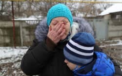 A view from Grabari village as a woman and her grandchild speaking after a shelling, in the pro-Russian separatists-controlled Donetsk, Ukraine on March 5, 2022.
