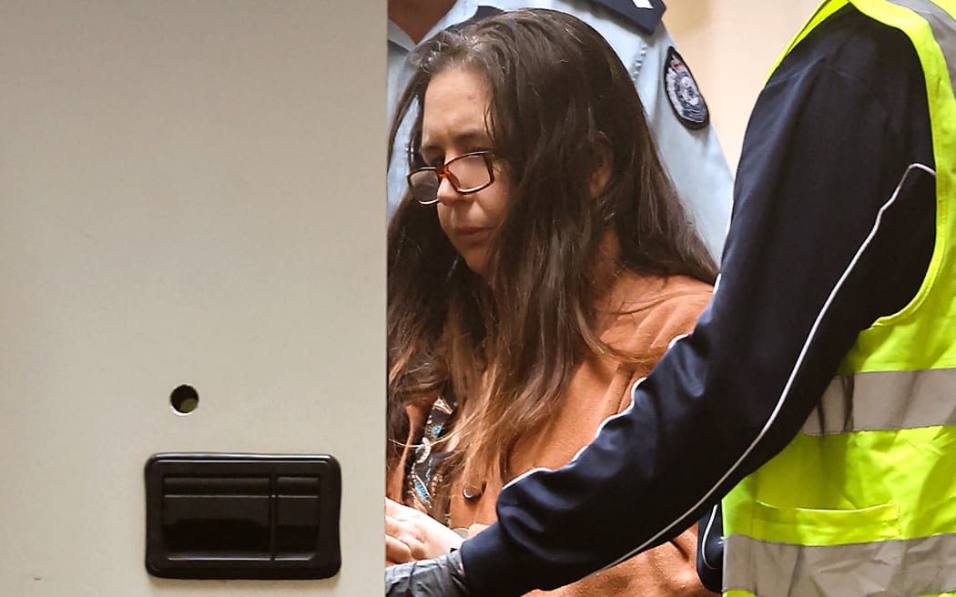 Convicted killer Erin Patterson leaves the Supreme Court of Victoria in Melbourne on September 8, 2025. An Australian judge sentenced Patterson on September 8 to life in prison with parole after 33 years for killing three people with toxic mushrooms, capping a trial that sparked a global media frenzy. (Photo by MARTIN KEEP / AFP)