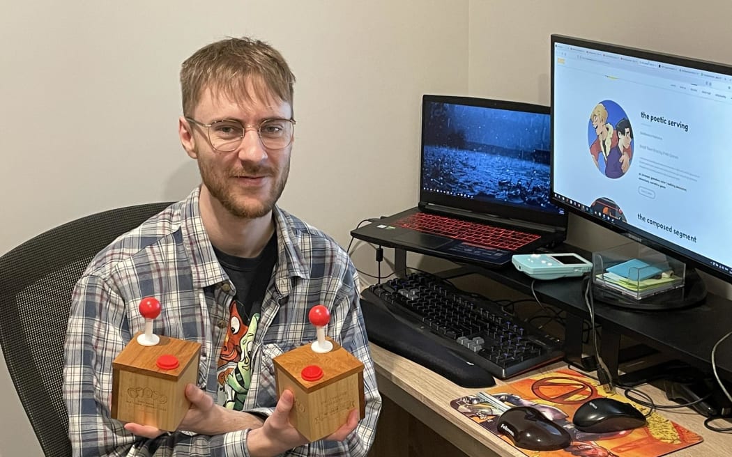 Thomas Barrer holding his two NZ Game Awards