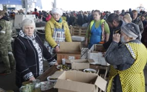 Mariupol residents seeking food and drink on Friday. A humanitarian aid centre continues to operate in Mariupol, where the Russian Army has taken control.