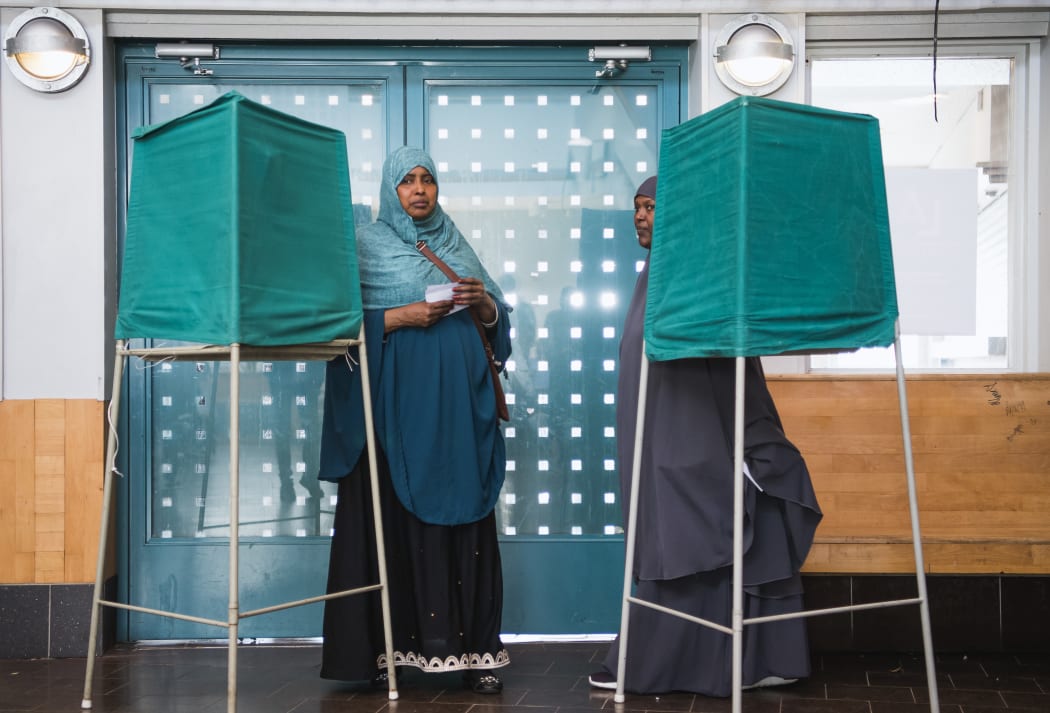 People stand on booths at a polling station during the Swedish general elections in the suburb of Rinkeby, north of Stockholm.