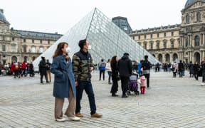 Chineese tourists wear face mask near the Louvre Museum in Paris, France, on 26 January 2020. (Photo by Jerome Gilles/NurPhoto)