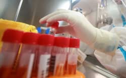 This photo taken on August 13, 2021 shows a laboratory technician wearing personal protective equipment (PPE) working on samples to be tested for the Covid-19 coronavirus at a Covid-19 testing facility in Yangzhou in China’s eastern Jiangsu province.
