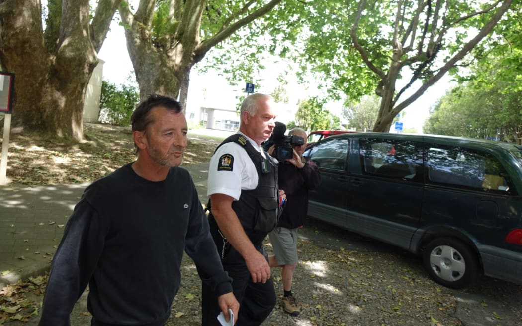Phil Rudd leaves the court after breaching his bail conditions by being in the same shop as a witness.