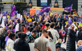 Nurses and healthcare assistants strike outside Britomart Station in Auckland.