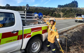 Dozens of firefighters remain at the site of a scrub fire on Lewis Pass Road in Canterbury, working to extinguish the blaze that forced evacuations yesterday.