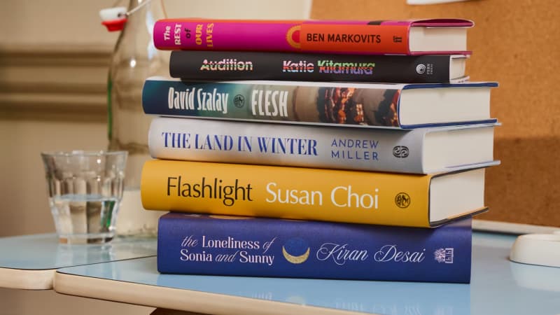 Six colourful books arranged in a stack.