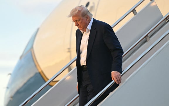 US President Donald Trump disembarks from Air Force One upon arrival at Joint Base Andrews in Maryland, May 4, as he returns to the White House after spending the weekend in Florida.