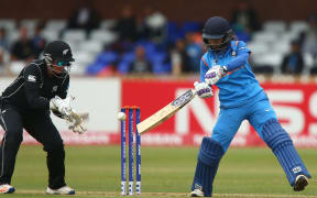 Mithali Raj of India plays a shot off in front of Rachel Priest of New Zealand.