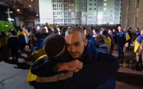 This handout photograph released by the official Telegram channel of Ukrainian President Volodymyr Zelensky on December 30, 2024, shows a Ukrainian prisoner reacting, after an exchange at an undisclosed location, amid the Russian invasion in Ukraine. - Russia and Ukraine swapped more than 300 prisoners of war on December 30, 2024 in an exchange brokered by the United Arab Emirates ahead of New Year's Eve, officials from both countries said. (Photo by HANDOUT / Telegram / @Volodymyr Zelensky / AFP) / RESTRICTED TO EDITORIAL USE - MANDATORY CREDIT "AFP PHOTO /  - / HANDOUT /  TELEGRAM /@VOLODYMYR ZELENSKY" - NO MARKETING NO ADVERTISING CAMPAIGNS - DISTRIBUTED AS A SERVICE TO CLIENTS