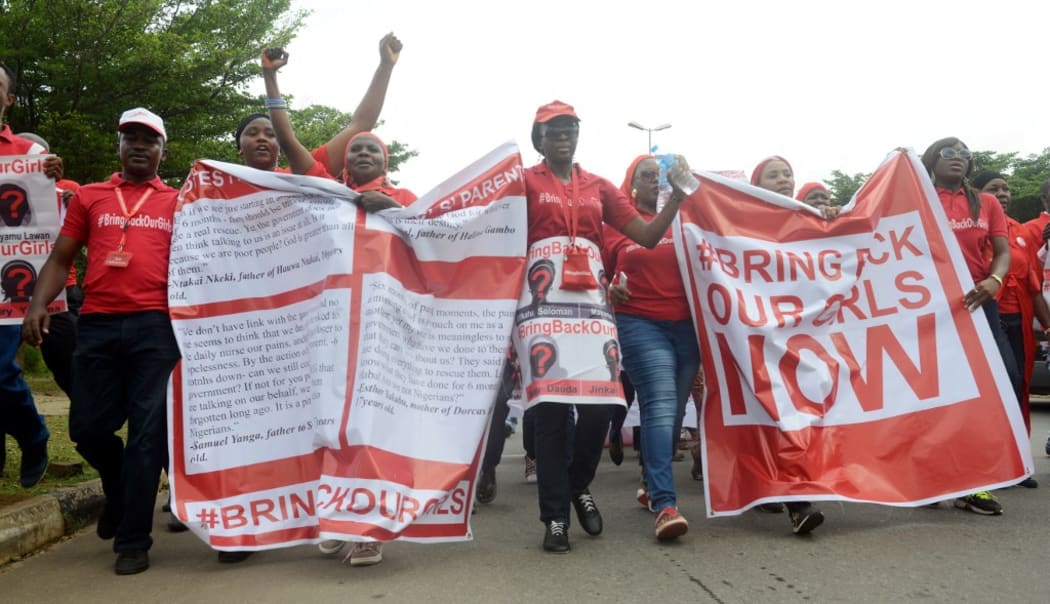 Supporters of the #BringBackOurGirls campaign march for the release of the 219 Chibok schoolgirls kidnapped by Boko Haram militants, in Abuja, on October 14, 2014.