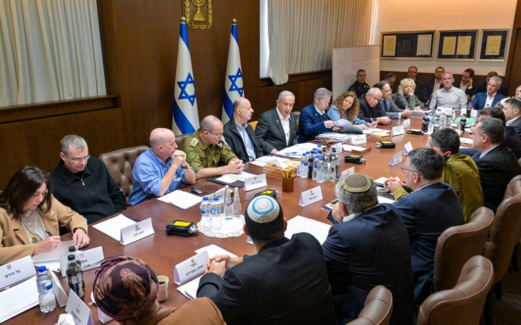 This handout picture released by the Israeli Government Press Office (GPO) shows Prime Minister Benjamin Netanyahu (6-L), heading a security cabinet meeting to vote on a Gaza ceasefire and hostage release deal that should take effect ton January 19, in Jerusalem on January 17, 2025. If approved, the agreement would halt fighting and bombardment in Gaza's deadliest-ever war and initiate on Sunday the release of dozens of hostages held in the territory since Hamas's October 7, 2023 attack on Israel. (Photo by Koby Gideon / GPO / AFP) / Israel OUT / ISRAEL OUT / ISRAEL OUT / XGTY / === RESTRICTED TO EDITORIAL USE - MANDATORY CREDIT "AFP PHOTO / HANDOUT /GPO' - NO MARKETING NO ADVERTISING CAMPAIGNS - DISTRIBUTED AS A SERVICE TO CLIENTS ==