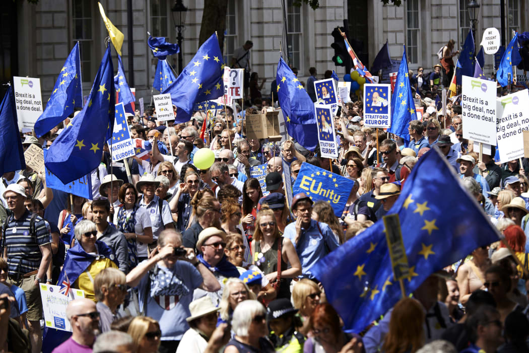 Demonstrators carry banners and flags as they participate in the People's March demanding a People's Vote on the final Brexit deal.