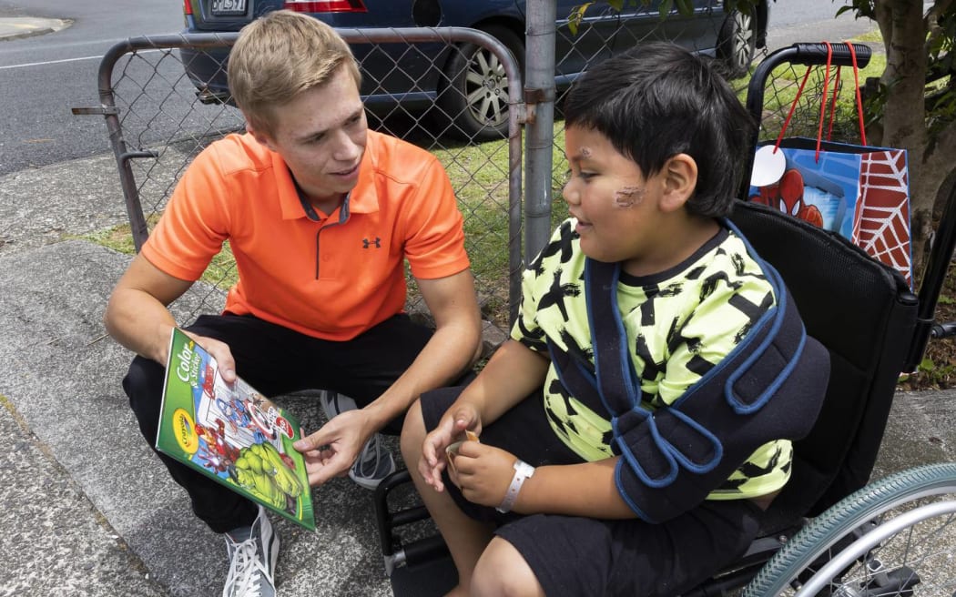 Matthew Denton brings gifts for Kharlo-Rae Pirini-Kiel on New Year's Day.