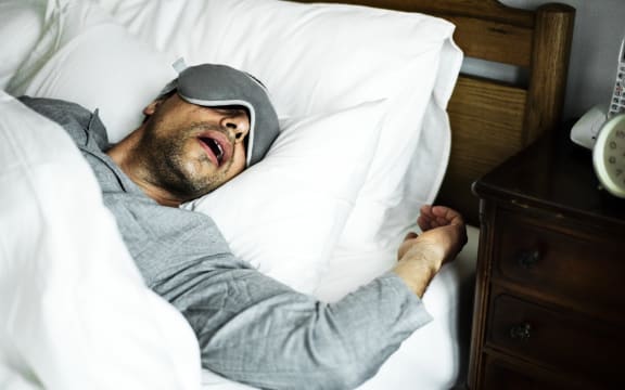 A man sleeping on a bed