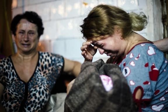 A mother with her newborn baby cries inside a bomb shelter during shelling in Donetsk at the weekend.