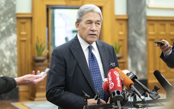 Winston Peters speaks to media on his way to the debating chamber in Parliament, Wellington.