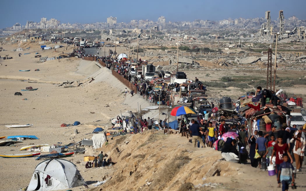 Displaced Palestinians move with their belongings southwards on a road in the Nuseirat refugee camp area in the central Gaza Strip following renewed Israeli evacuation orders for Gaza City on 16 September, 2025. Israel launched its long-anticipated ground assault on Gaza City at dawn, a day after winning backing from its top ally the United States despite mounting international alarm.