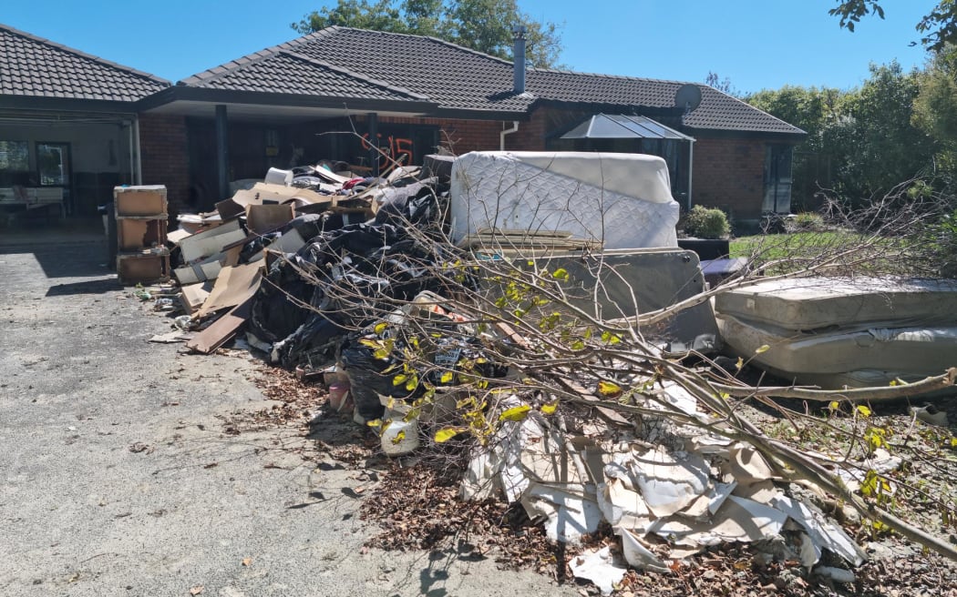 Destroyed items piled outside Peter Mitchell's house in Awatoto, Napier.