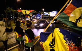 FLNKS supporters wave the Kanak flag of New Caledonia on the night of the second independence referendum in October 2020.