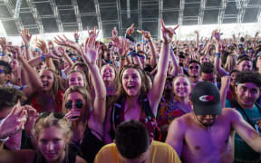 (FILES) In this file photo taken on April 15, 2018 fans cheer as Petit Biscuit performs at the Coachella Music and Arts Festival in Indio, California, -