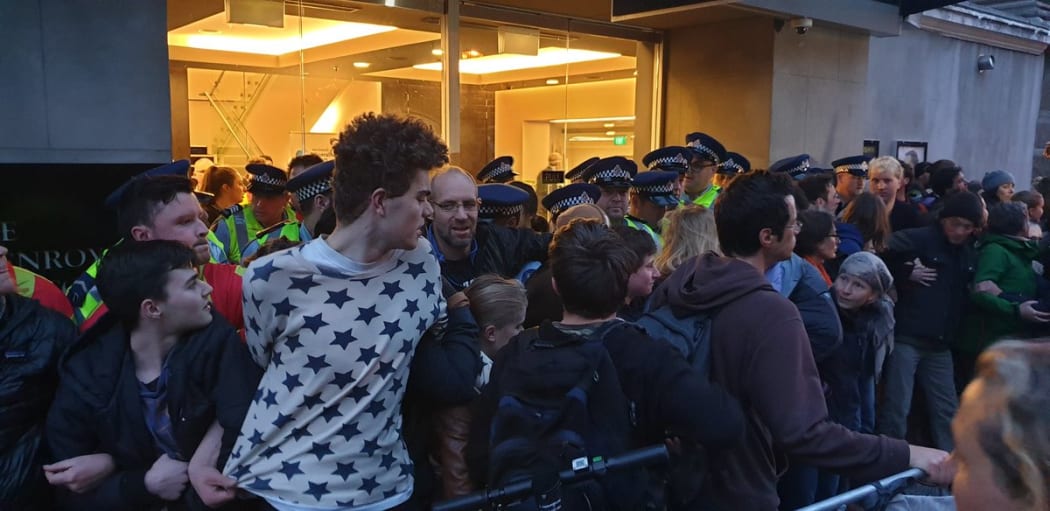 Protesters block the entrance to the conference.