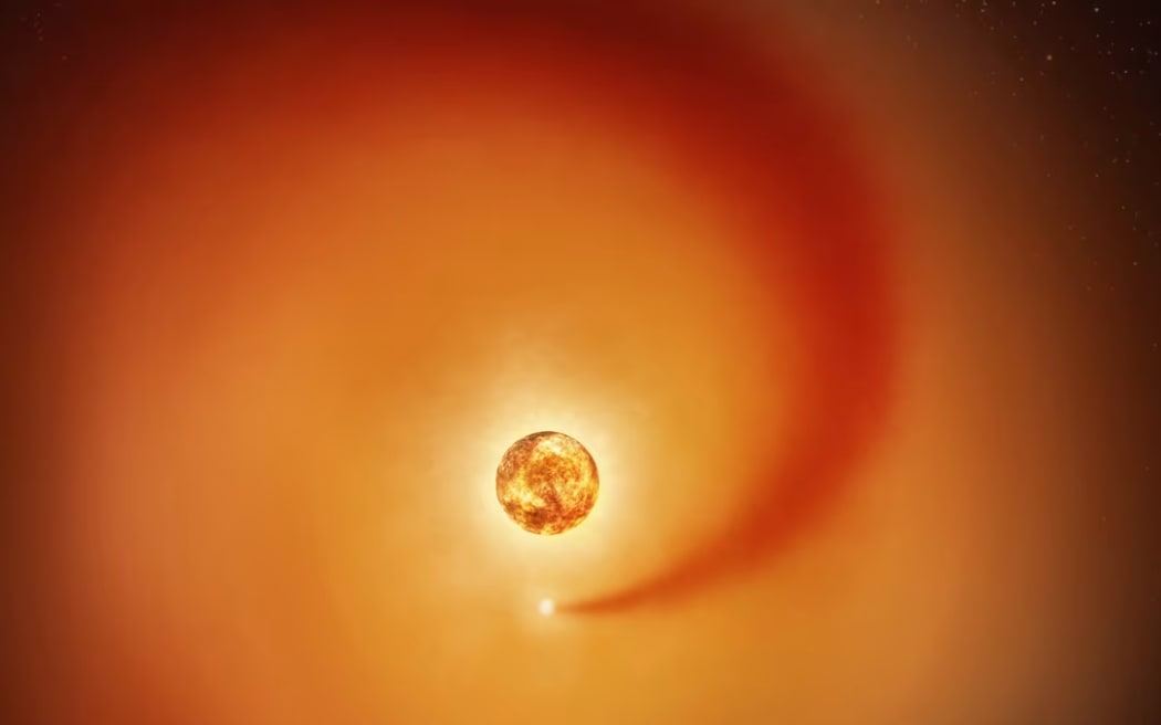 This artist’s concept shows the red supergiant star Betelgeuse and an orbiting companion star creating a wake in the larger object's atmosphere.