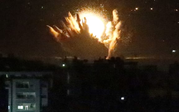An Israeli missile hits Palestinian buildings in Gaza City