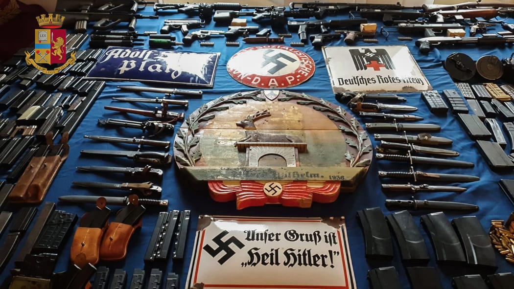 This handout photograph released by the Italian police of Turin, on July 15, 2019, shows a big cache of guns and ammunition that was seized by the Turin special police force